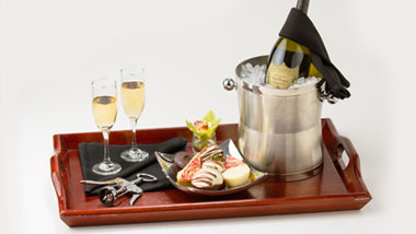 room service tray with desserts and champagne
